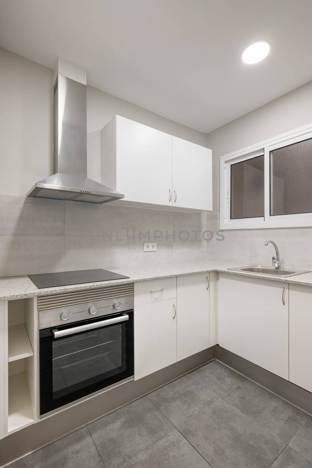 Modern kitchen interior featuring stainless steel appliances, sleek white cabinets, and a clean design. Ideal space for cooking and entertaining.