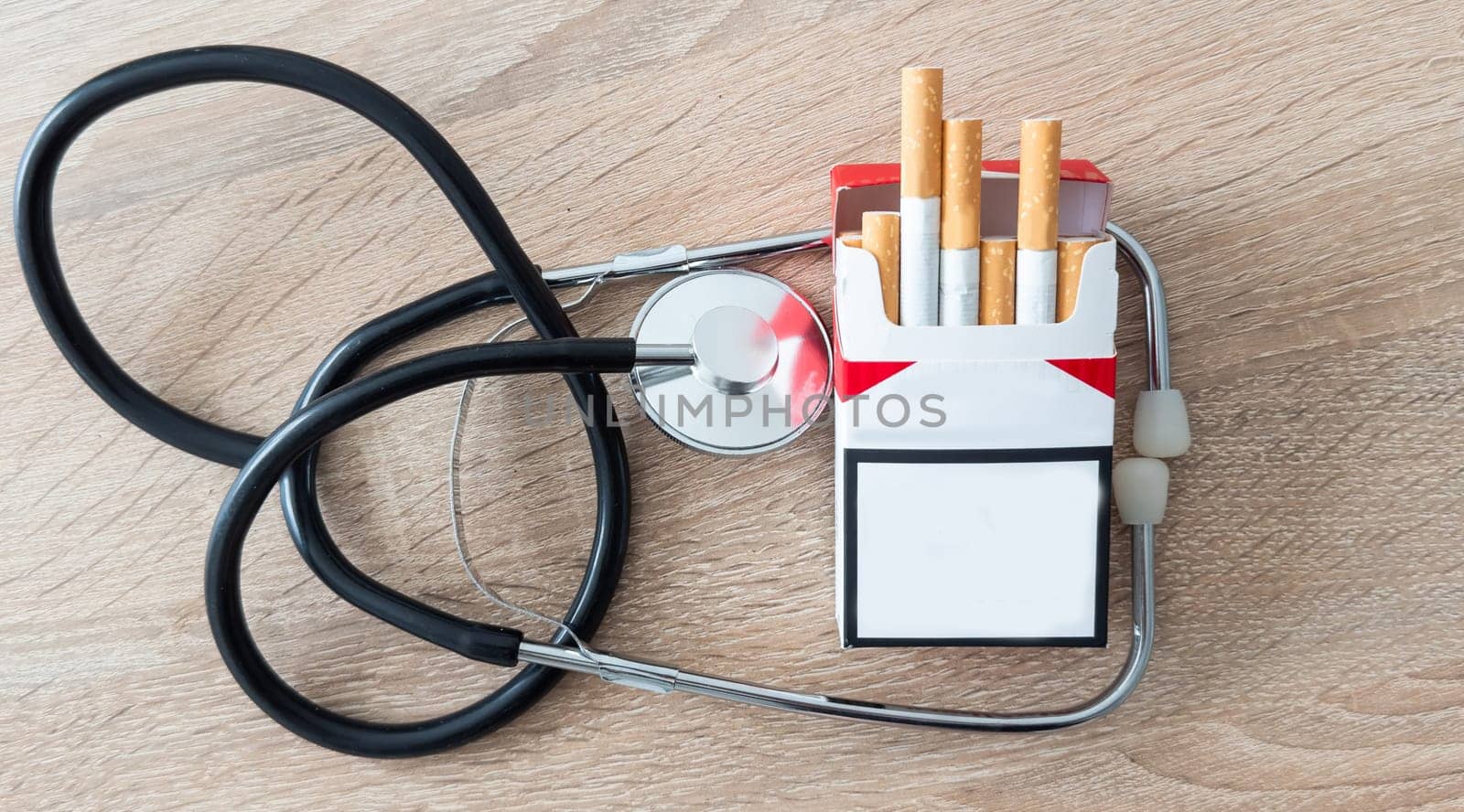Stethoscope and cigarette isolated on white background. Medical concept. High quality photo