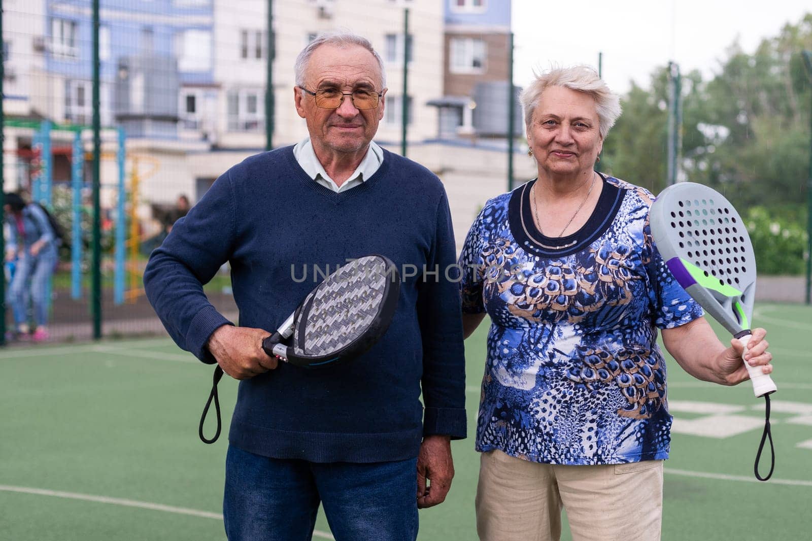 senior man playing paddle tennis . High quality photo