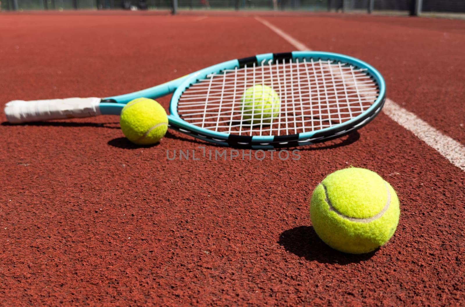 Tennis scene with balls, racquets and hard court surface corner lines. High quality photo