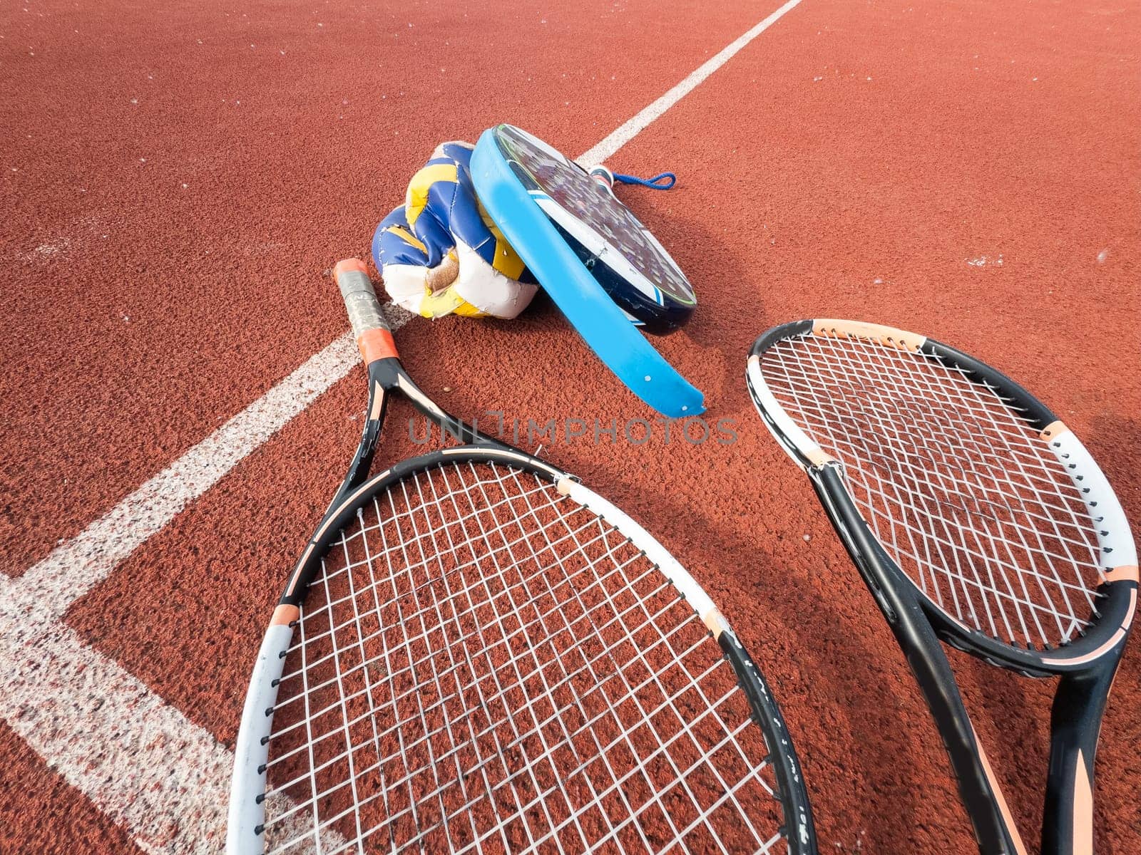 The broken rackets for playing tennis are hanging on the wall of a sports tennis club. . High quality photo