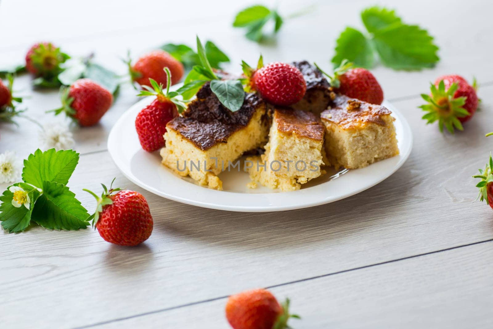 prepared cottage cheese casserole with fresh strawberries .