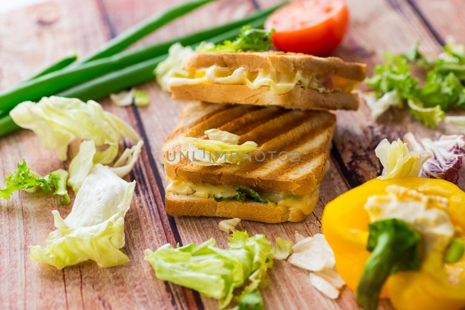 fried toasts with filling, salad leaves, tomatoes .