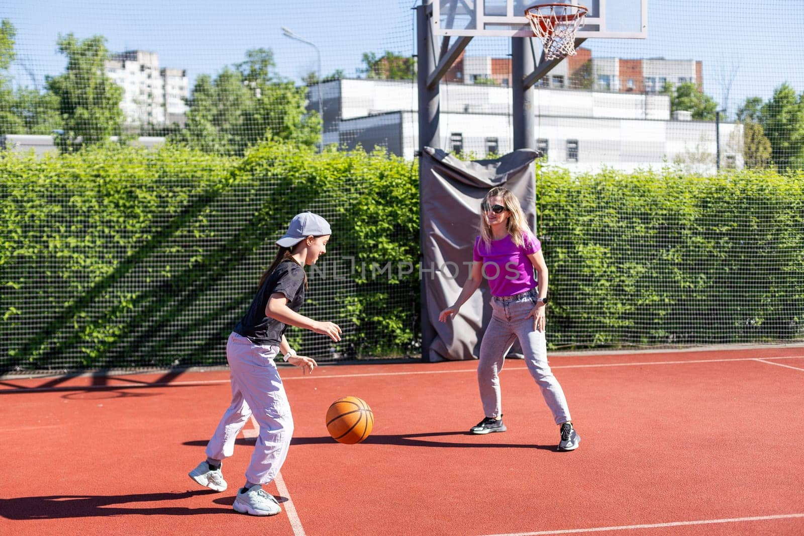 Mother and daughter playing basketball. High quality photo