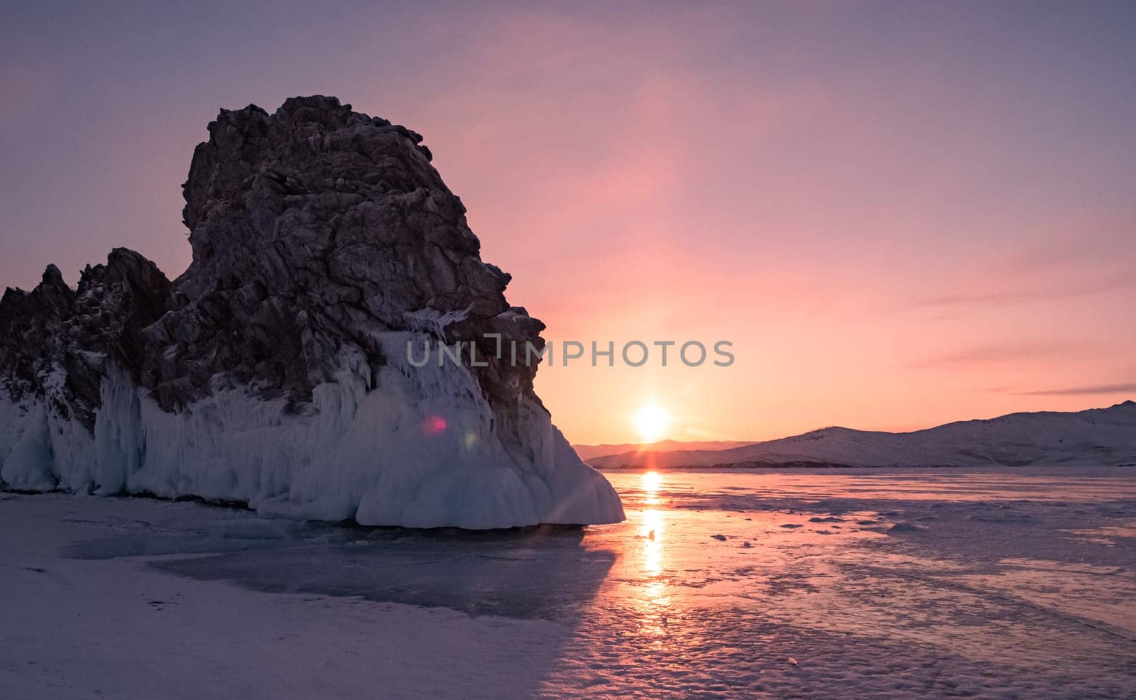 Ogoy island on winter Baikal lake. Winter scenery of Dragon Tail Rock on Ogoy island during sunrise at Lake Baikal. by Busker