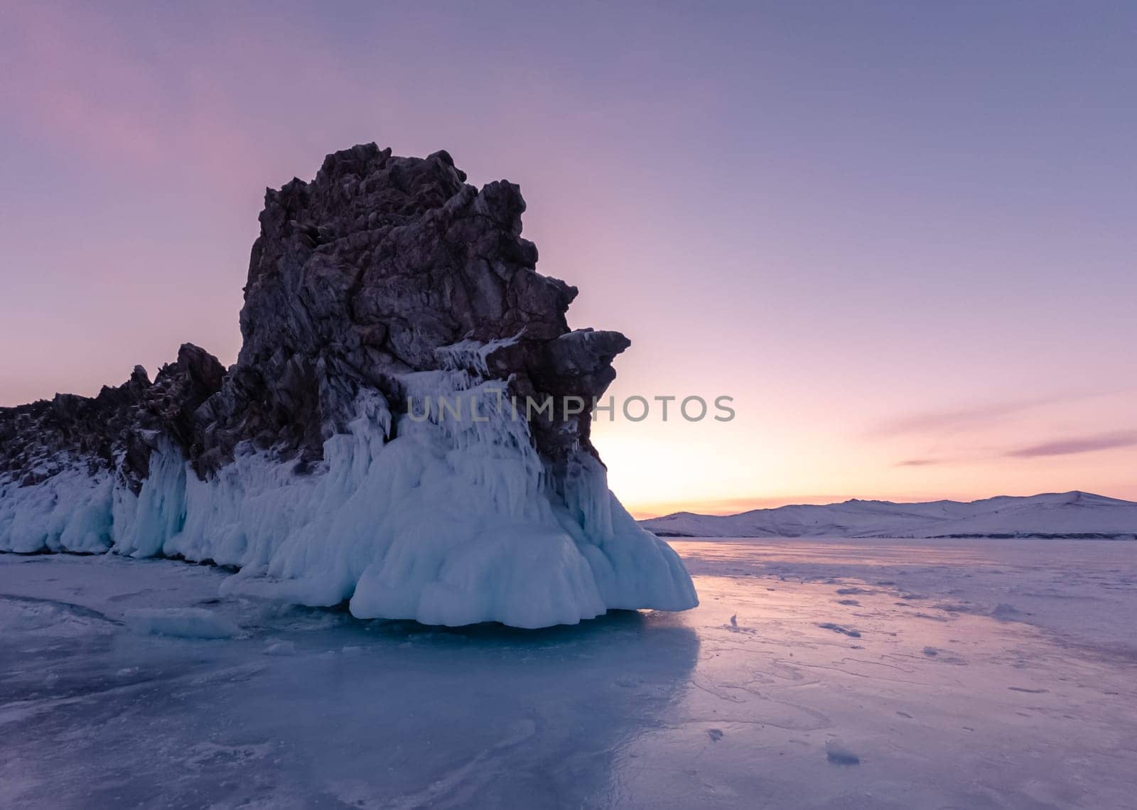 Ogoy island on winter Baikal lake. Winter scenery of Dragon Tail Rock on Ogoy island during sunrise at Lake Baikal.