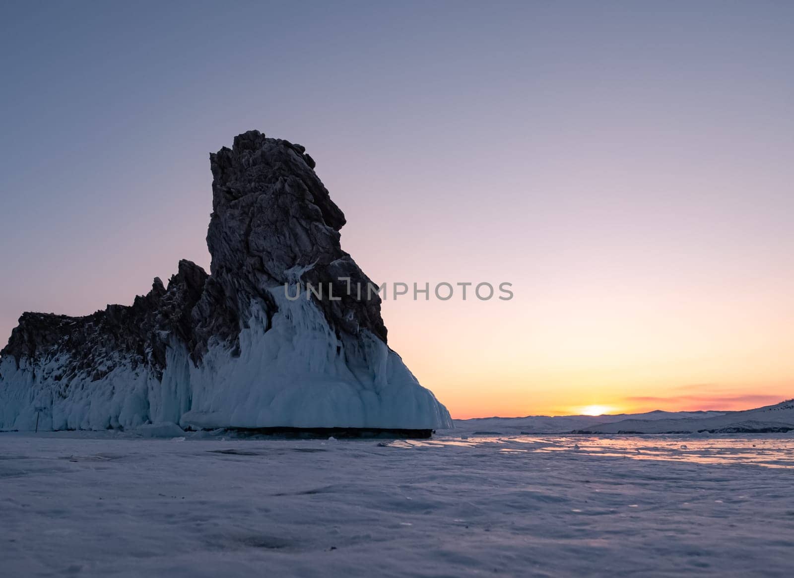 Ogoy island on winter Baikal lake. Winter scenery of Dragon Tail Rock on Ogoy island during sunrise at Lake Baikal. by Busker