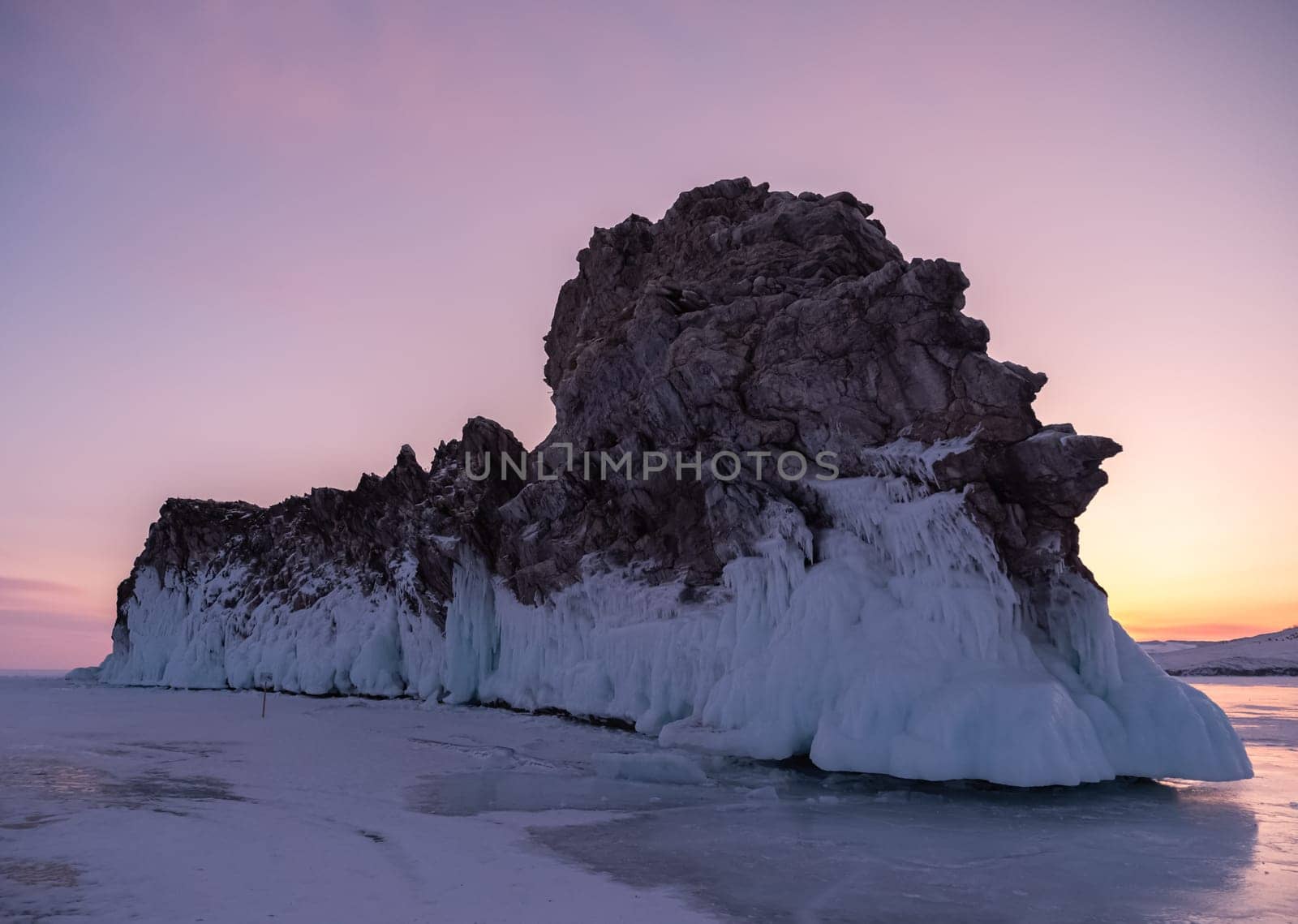 Ogoy island on winter Baikal lake. Winter scenery of Dragon Tail Rock on Ogoy island during sunrise at Lake Baikal.