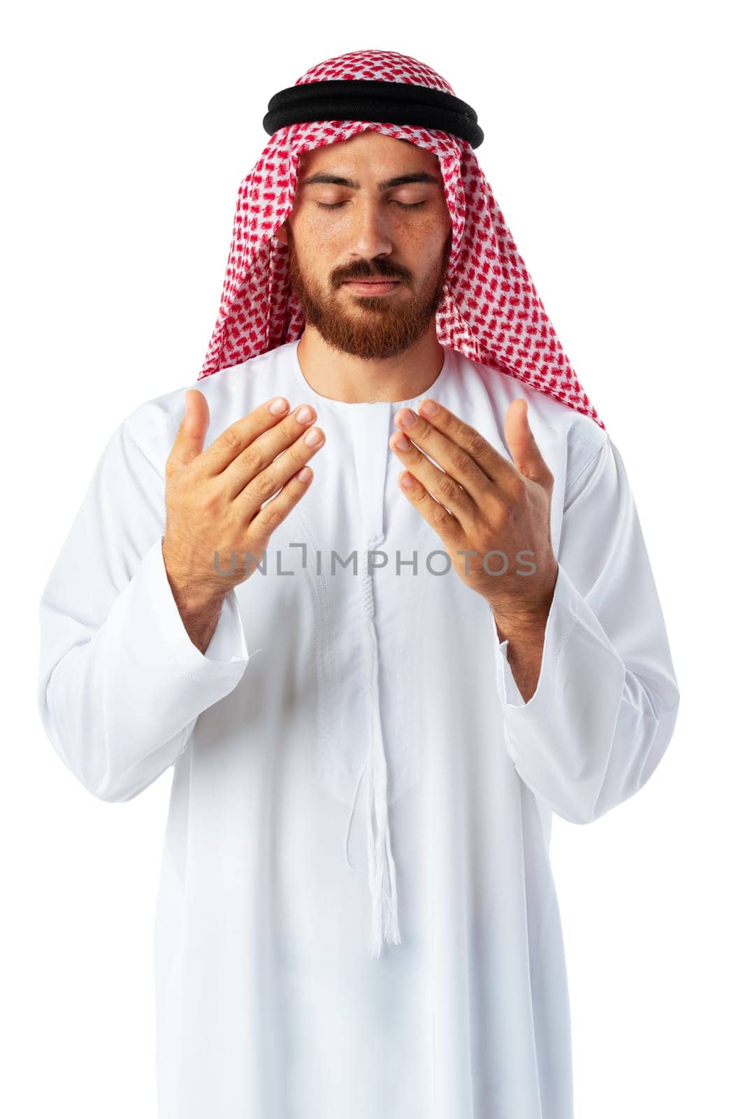 Young Arab man in traditional clothing praying isolated on white background