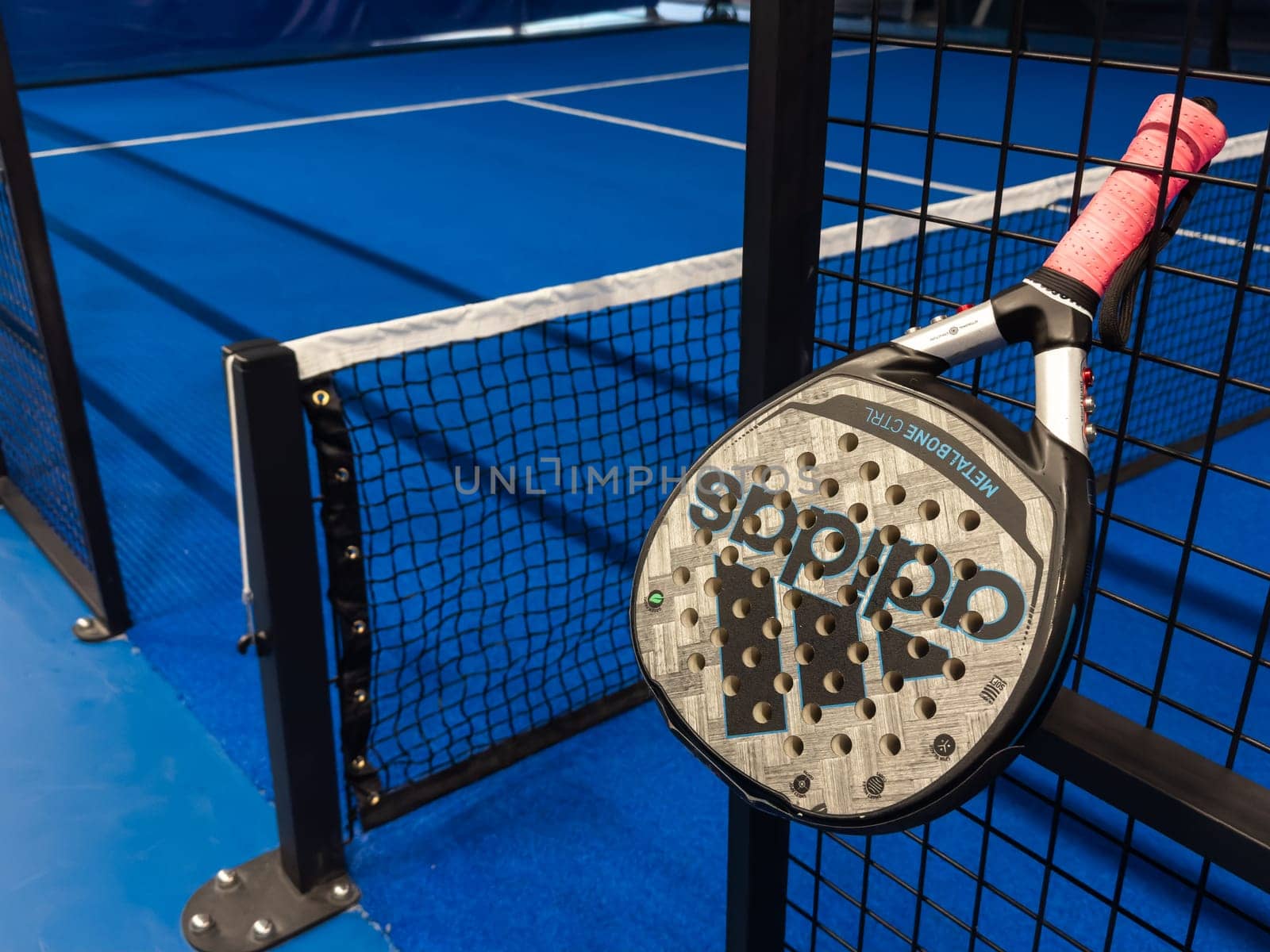 Ukraine Kyiv, May 23 2024. paddle tennis racket and balls on the blue paddle court. High quality photo