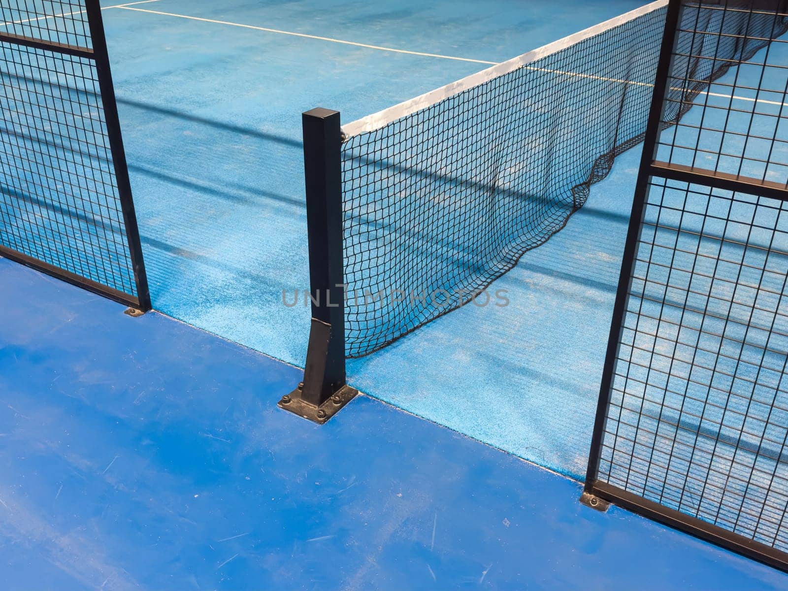 Blue padel and tennis net and hard court. Tennis competition concept. Horizontal sport theme poster, greeting cards, headers, website and app . High quality photo