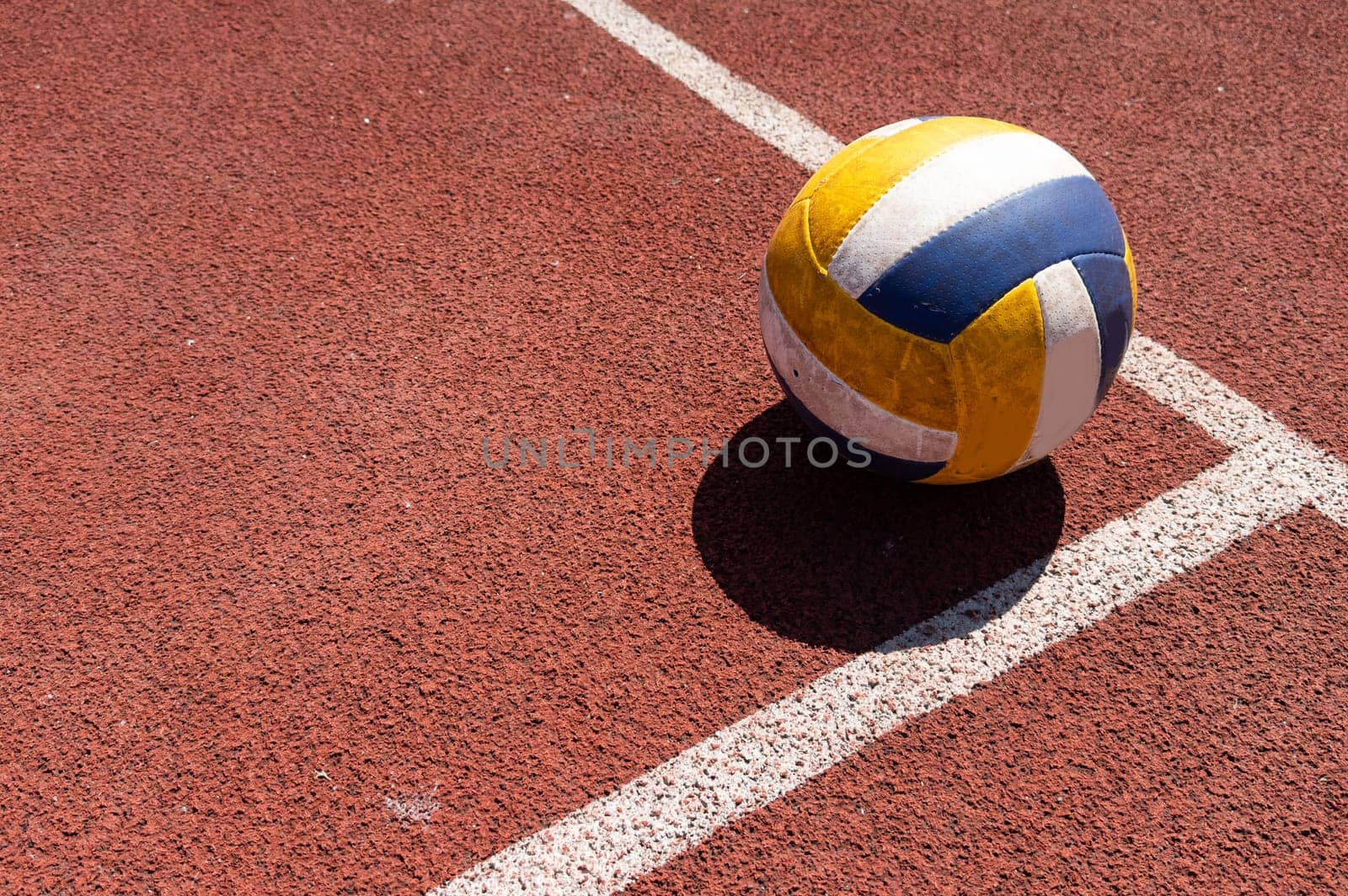 volleyball. blue with yellow color ball on the playground. volleyball cover, red. ball game. High quality photo