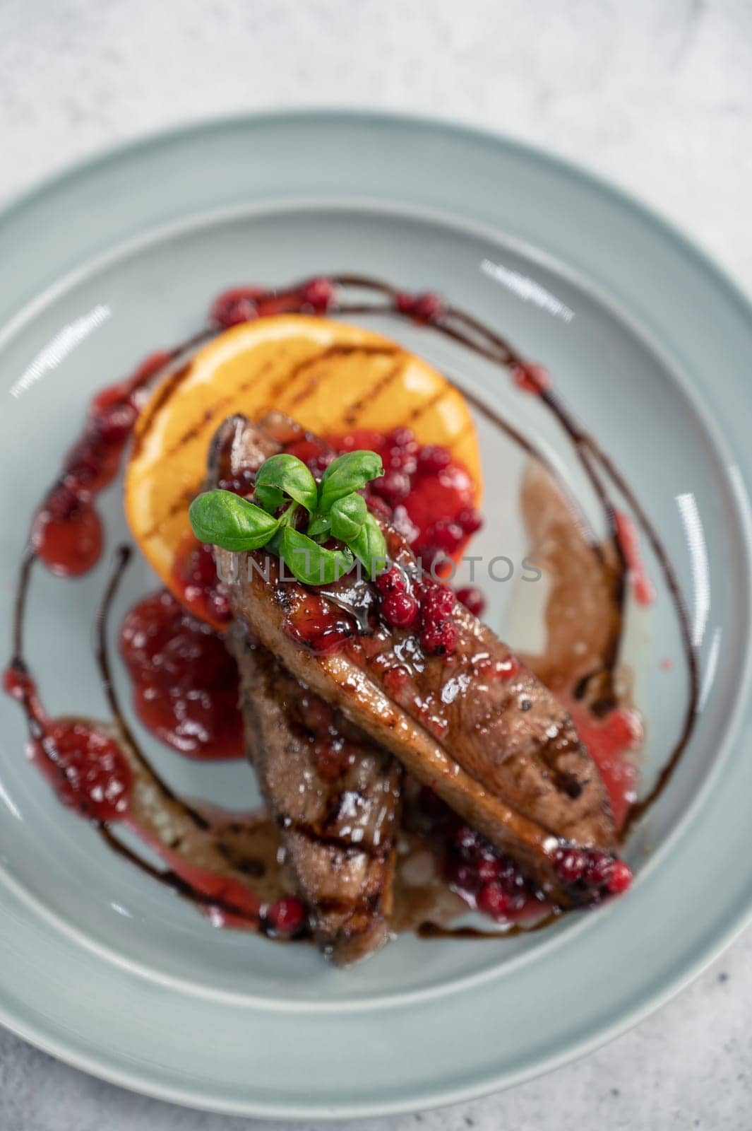 Tasty duck breast with orange and berries