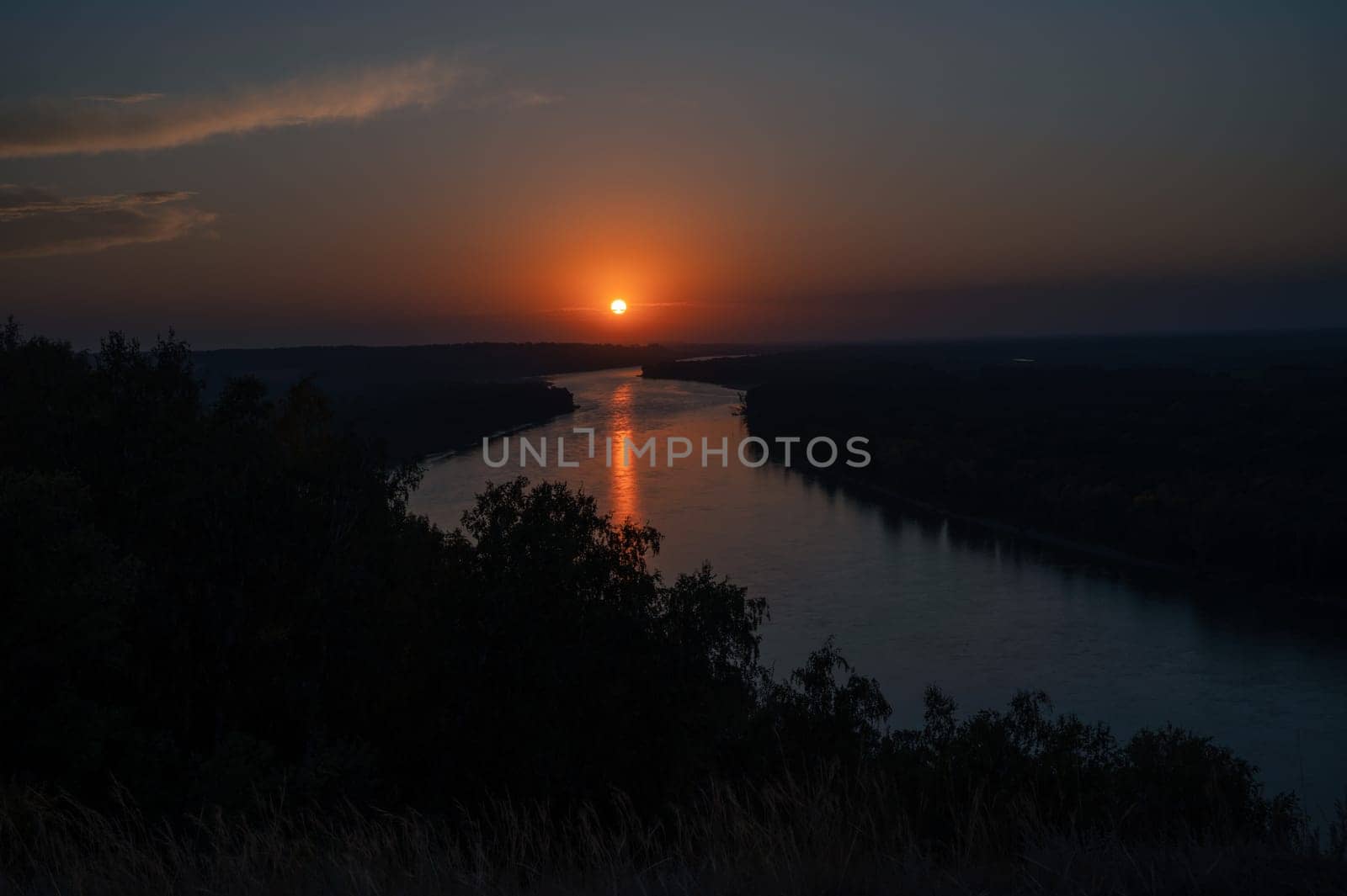 View of river landscape in sunny summer sunset. Top view of siberian Ob river from high attitude in summer sunset.