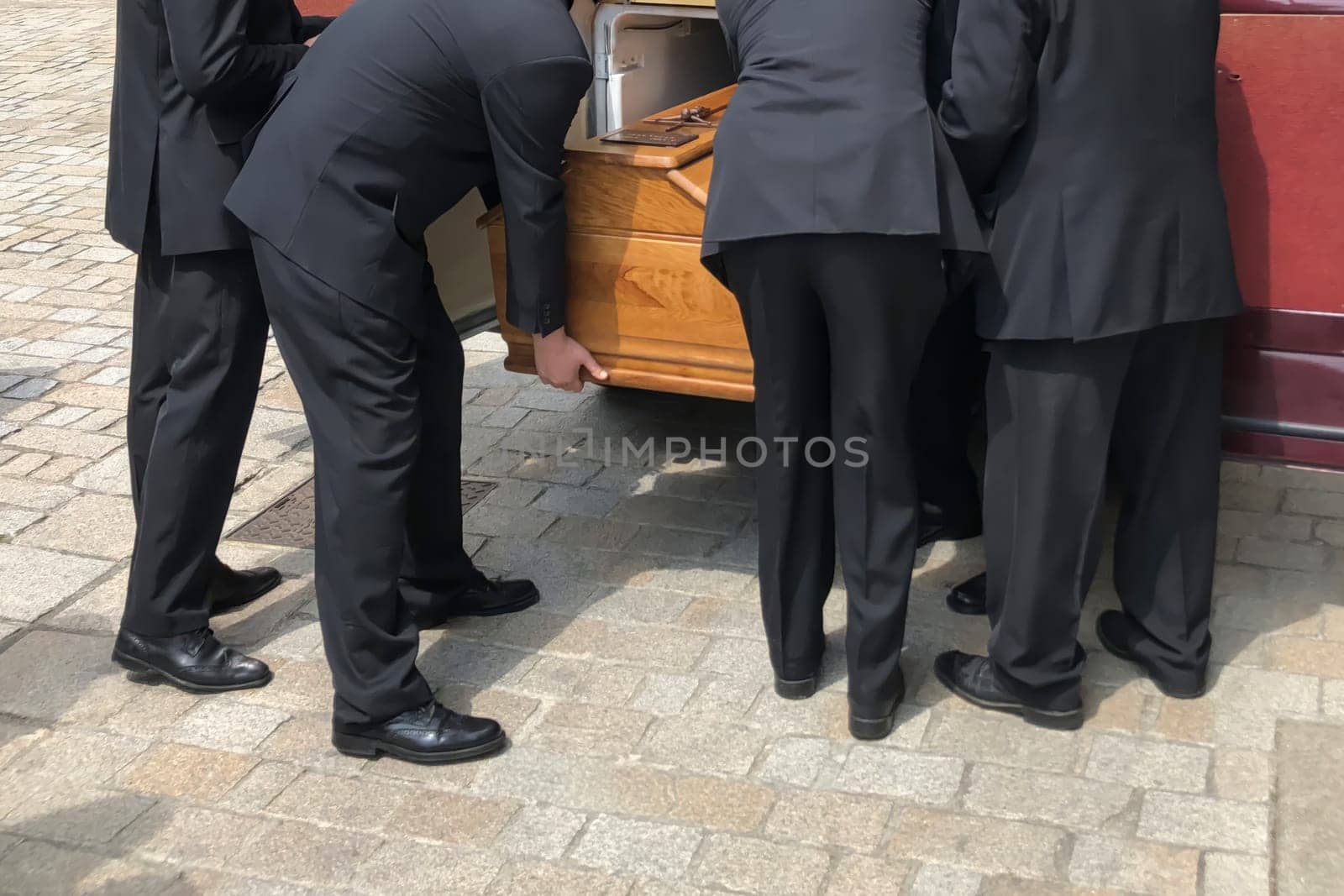 Funeral service loading the coffin into the hearse