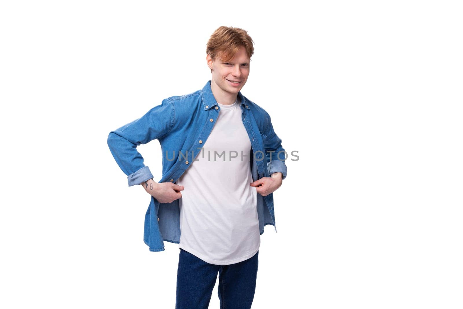 young man with red hair in a blue shirt over a white t-shirt with a mockup for advertising.