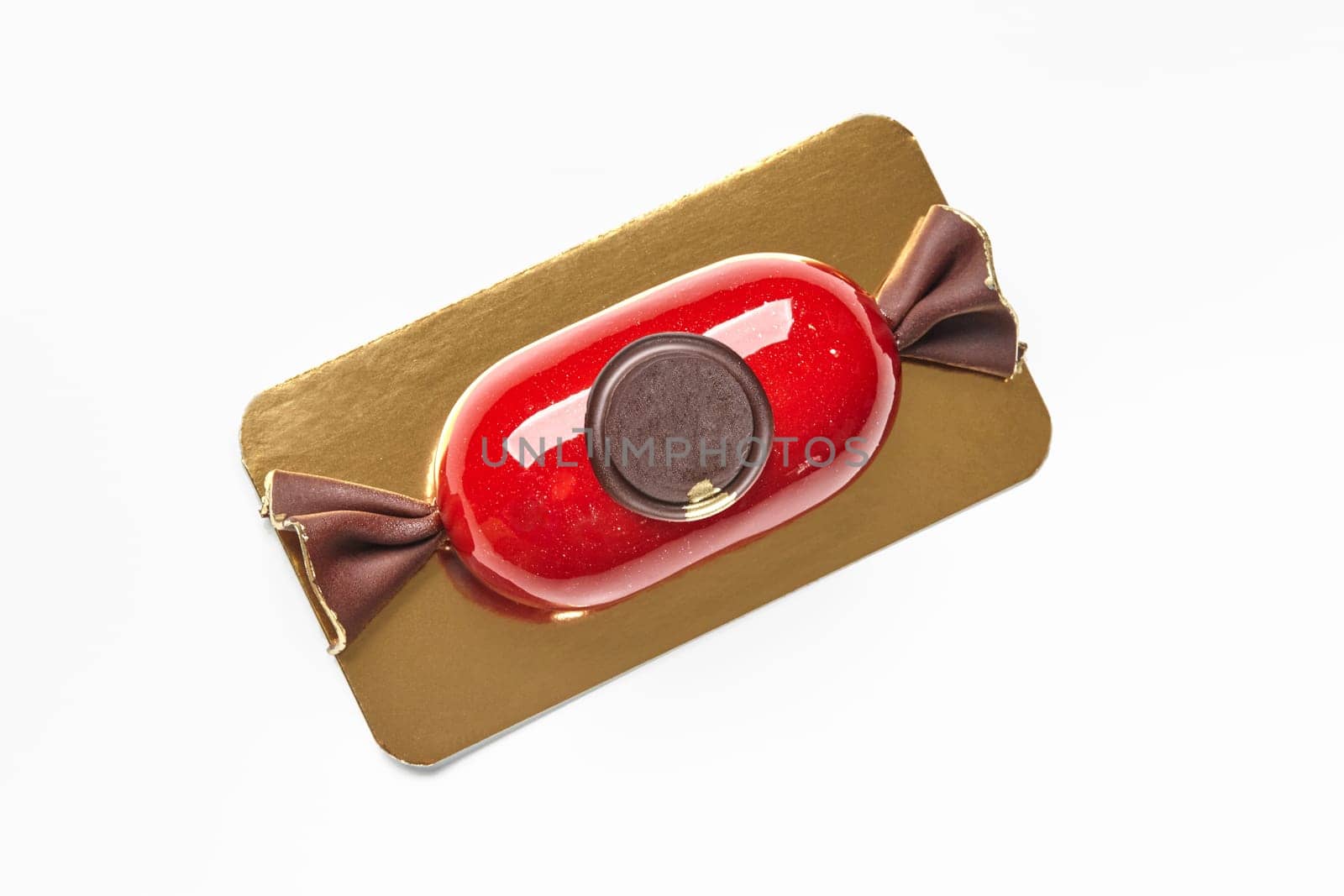 Candy-shaped mousse dessert with red glaze and chocolate seal by nazarovsergey