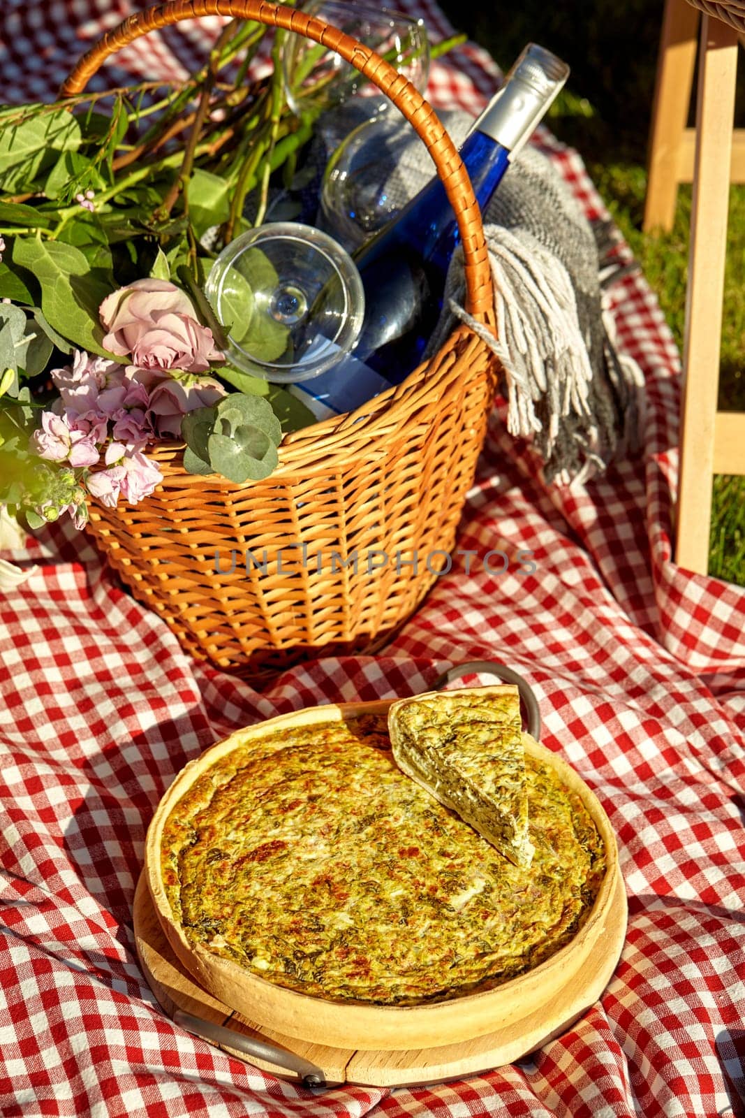 Savory quiche with bottle of wine for romantic summer picnic by nazarovsergey