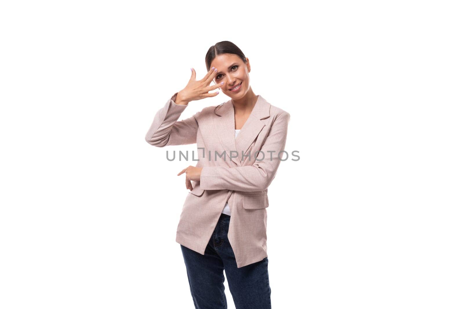 young attractive european brunette woman dressed in a stylish beige jacket on a white background with copy space.