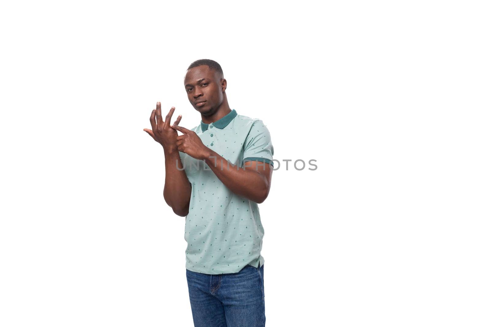 a young smart American guy dressed in a mint T-shirt counts on his fingers.