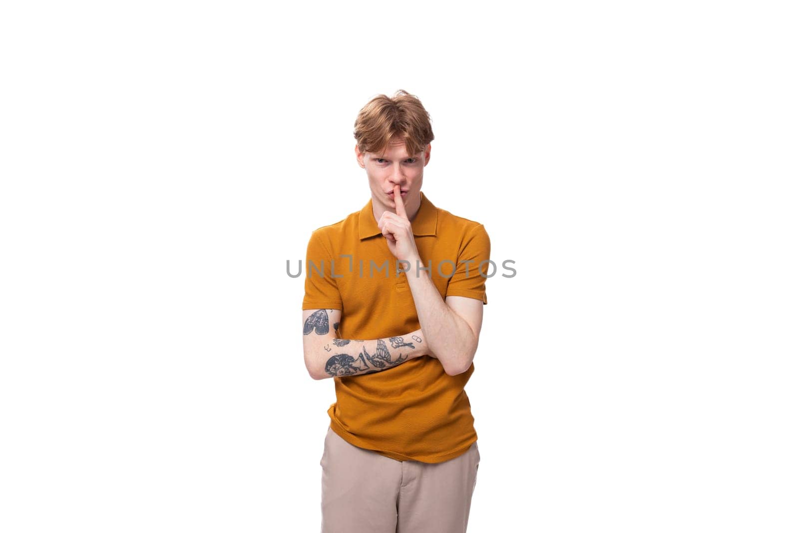 young smart redhead man in yellow t-shirt isolated on white background.