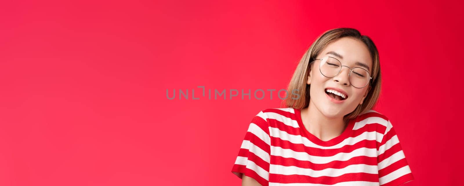 Happy dreamy glad asian girl feel stuffed good after eating favorite sandwich, woman wear glasses close eyes delighted smiling broadly opened mouth fantasizing, dreaming tasty burger.