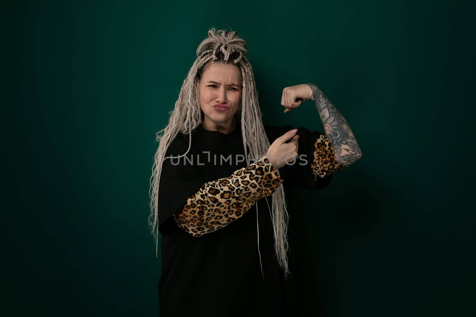 A woman with long hair is shown wearing a leopard print arm sleeve. Her hair flows down past her shoulders, framing her face. The leopard print sleeve covers her arm, adding a bold and edgy touch to her outfit.