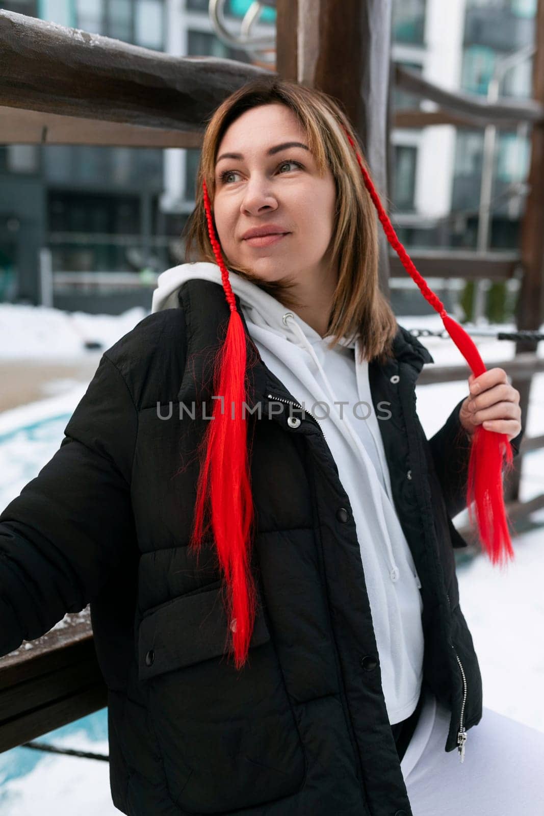 Young carefree woman spending interesting time outdoors in winter.
