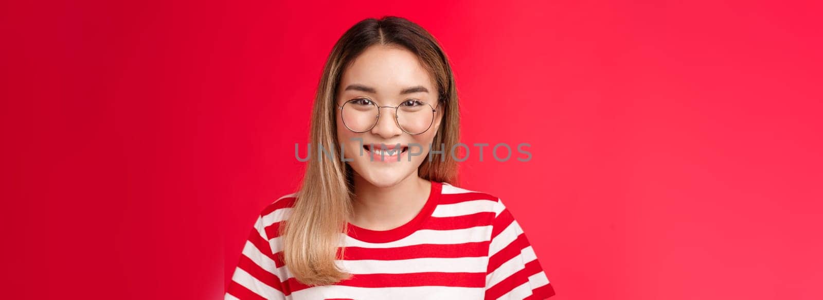 Close-up cheerful asian blond girl wear glasses smiling pleasant, give friendly toothy grin camera talking casually friends, standing happy show positive pleasant emotion, stand red background.