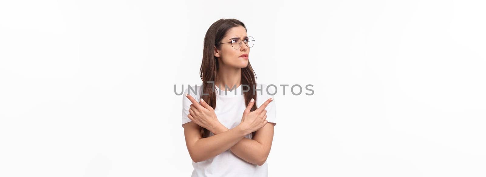 Waist-up portrait of troubled, thoughtful and indecisive young 20s woman in glasses, frowning skeptical and hesitant, cross hands pointing left and right, two variants both good, thinking what choose.