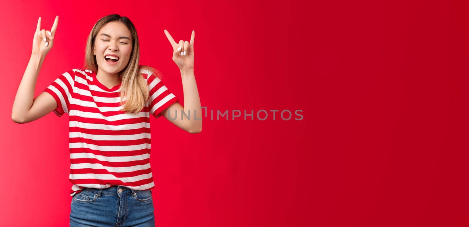 Upbeat wild reckless blond asian girl having fun losing control, showing rock-n-roll sign enjoy awesome party yelling singing along cool concert, heavy metal sign close eyes, stand red background by Benzoix