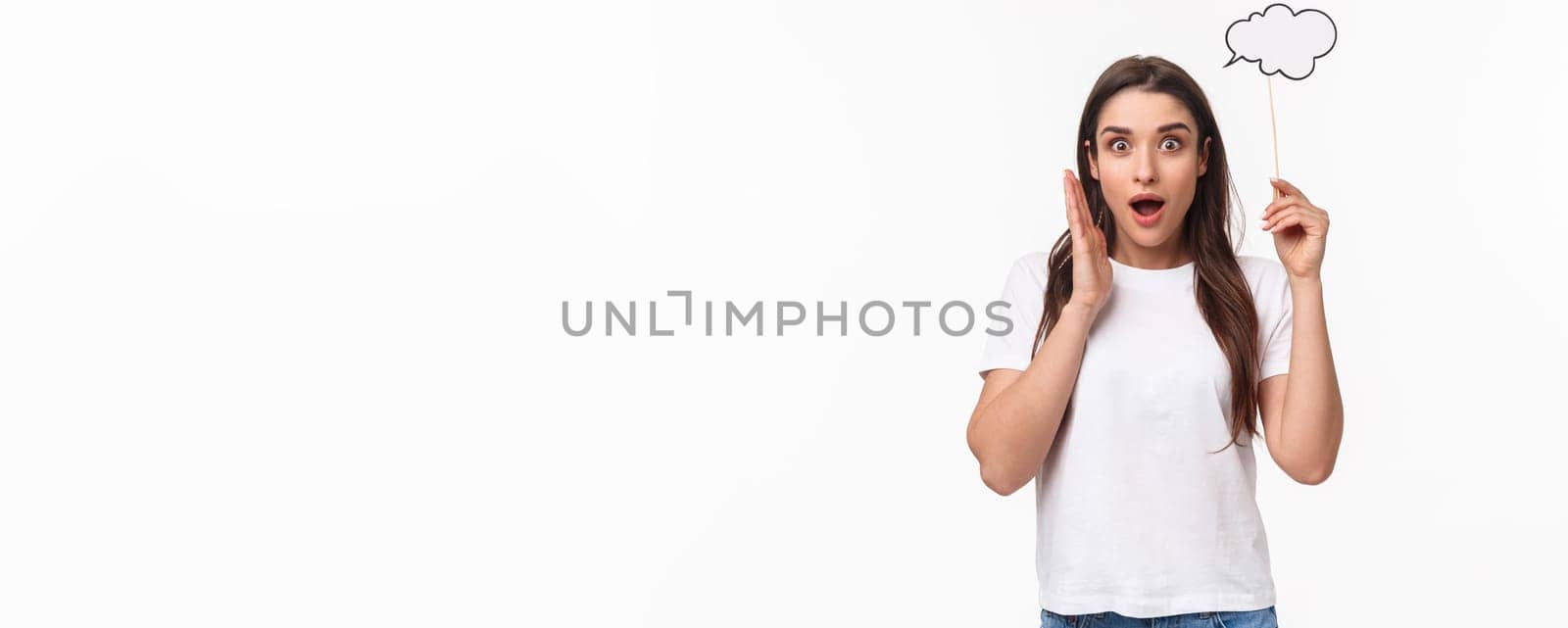 Entertainment, fun and holidays concept. Portrait of excited and happy, surprised young girl have awesome idea, holding comment cloud near head as if have plan, thinking, gasping in awe by Benzoix