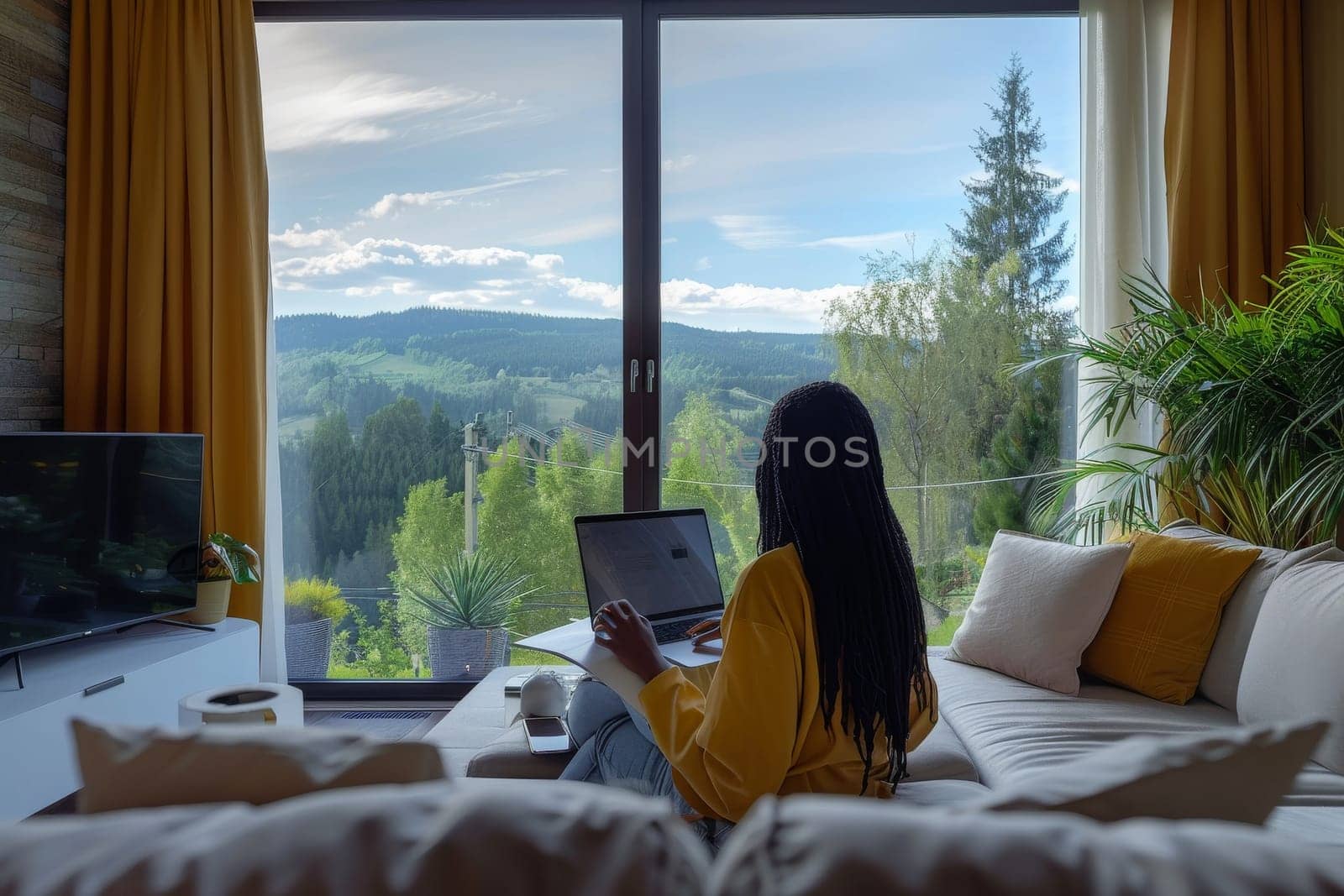 American African woman working with laptop at luxury home.