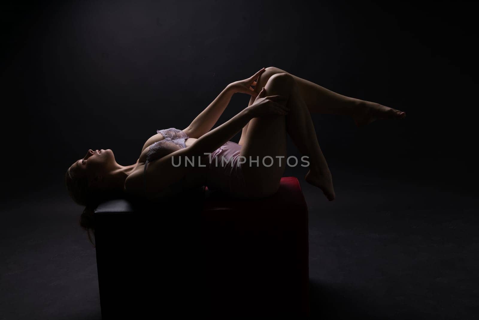 Photo of a gentle seductive topless plump lady isolated on black background