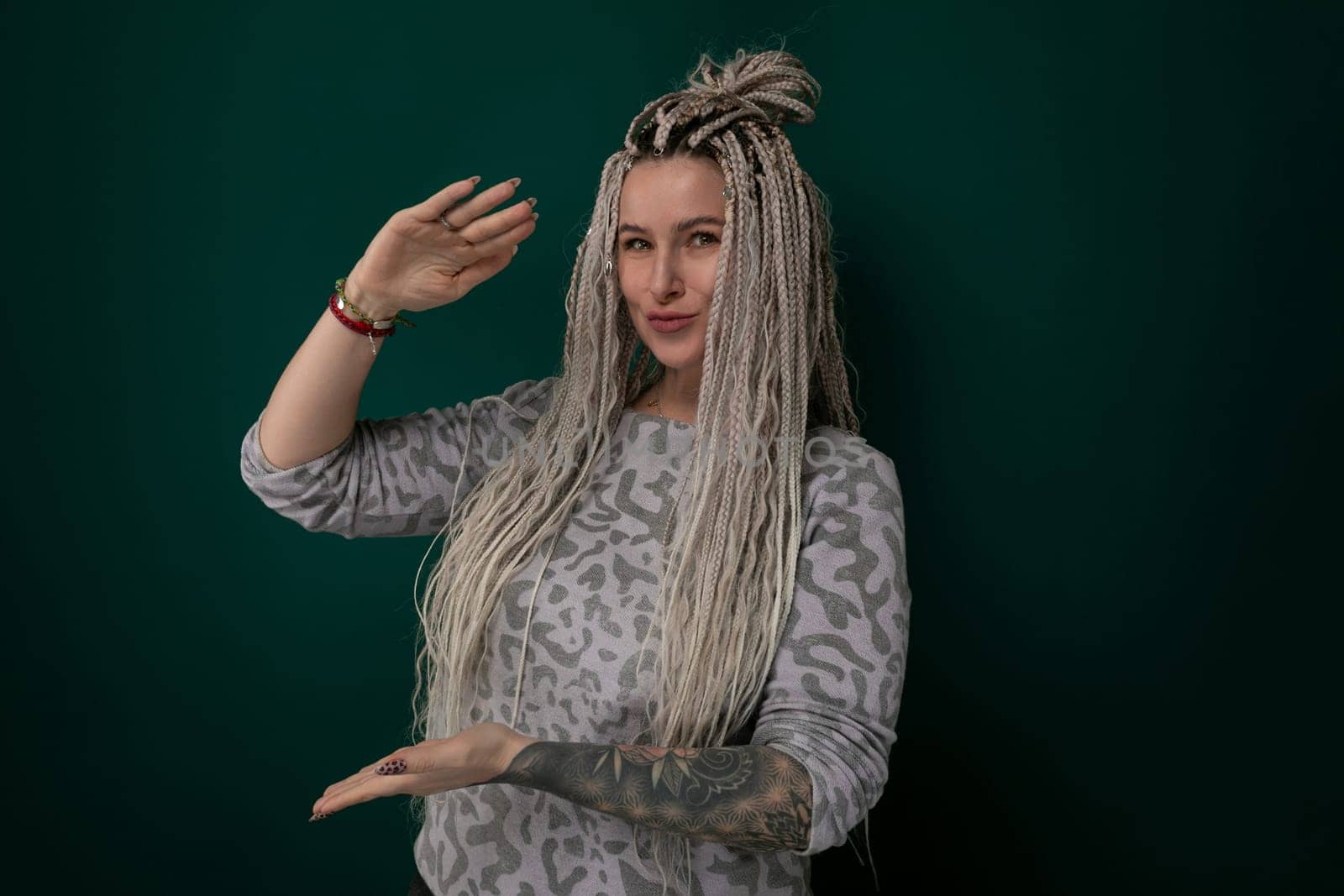 A woman with long blonde hair is standing, wearing a leopard print top. She looks confident and stylish in her outfit, showcasing the bold print.