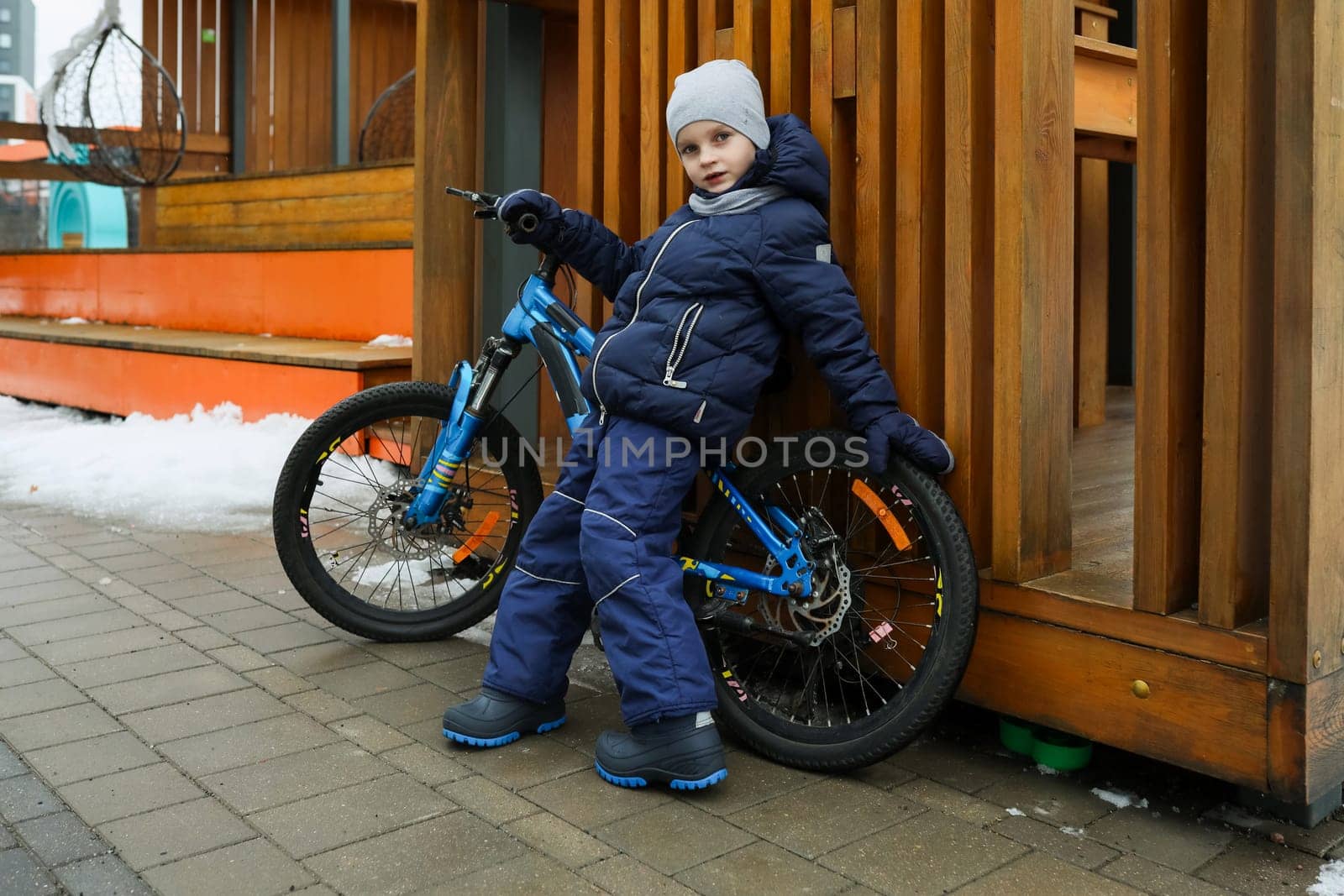 Child boy likes to spend time riding a bike.