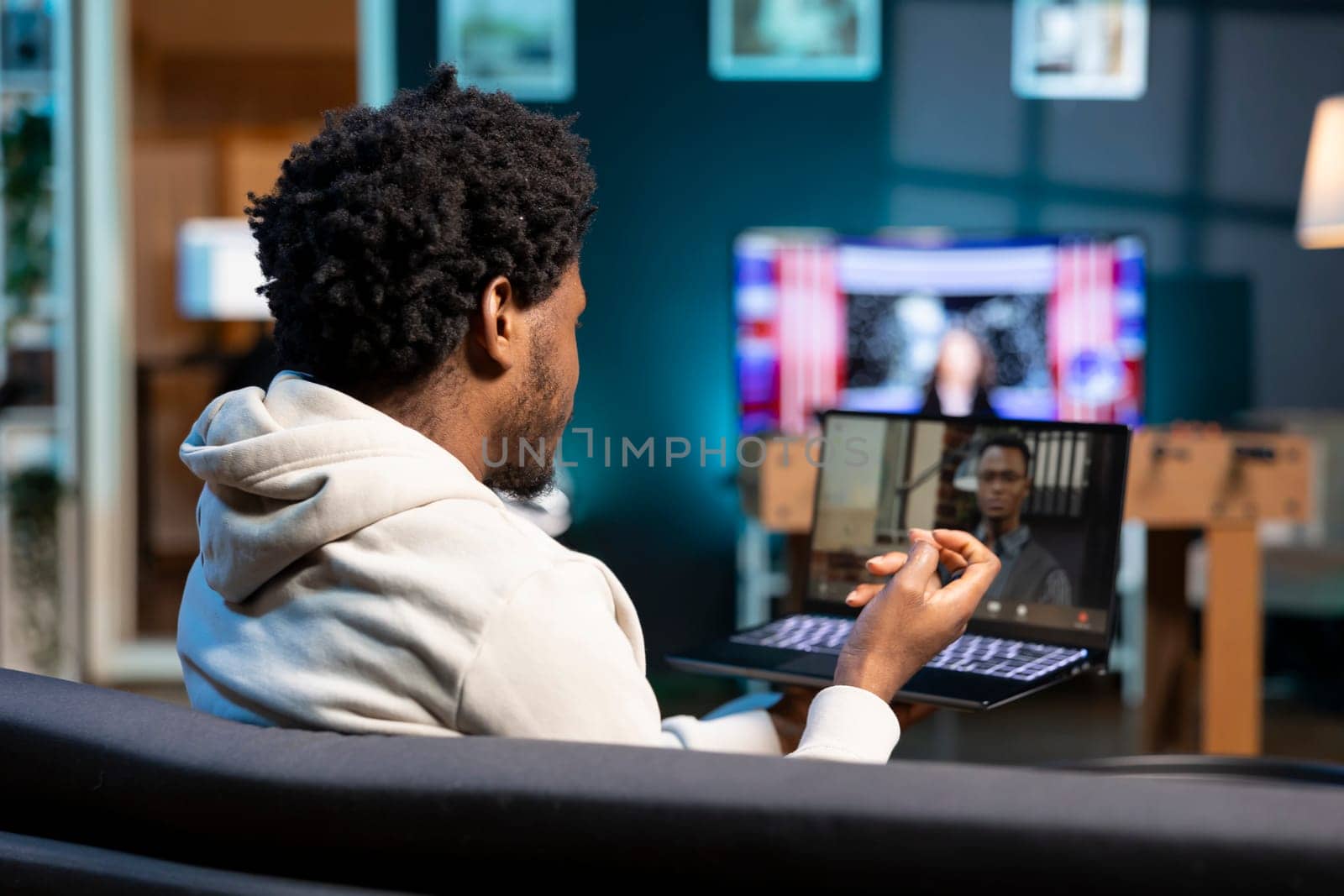 Prospecting job candidate remotely being interviewed via online video call by manager. Man answering human resources interview questions during videoconference meeting while staying at home