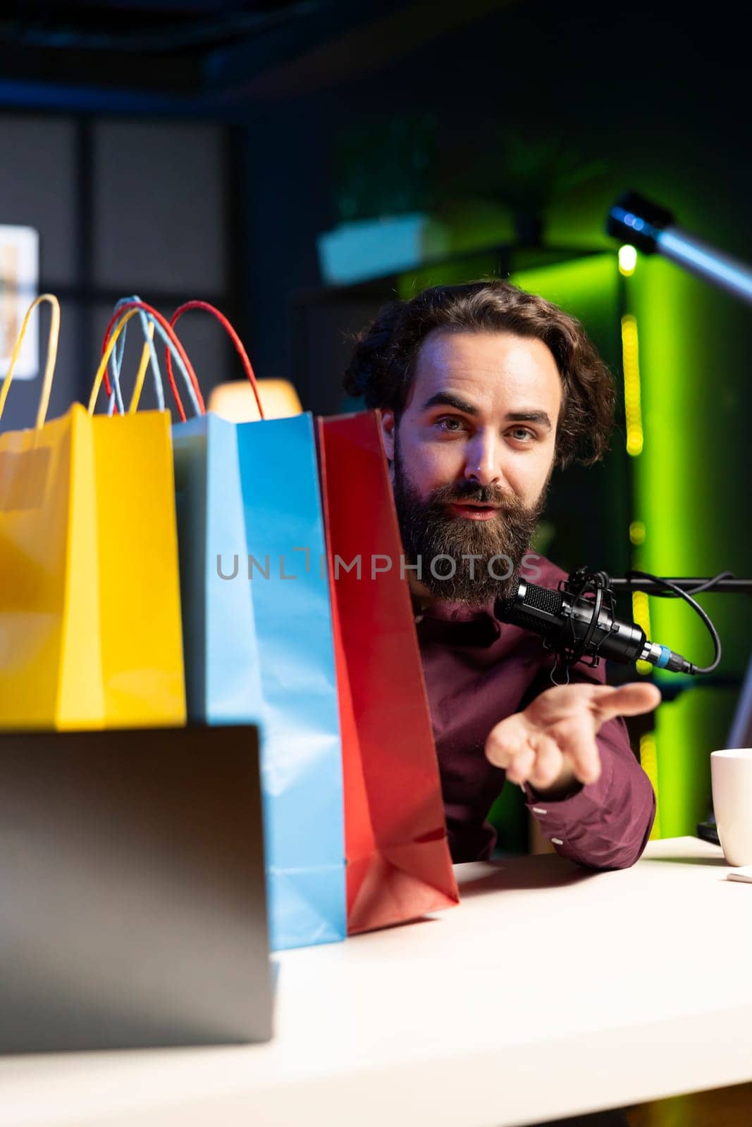 Content creator filming fashion vlog, unboxing bags with internet order, showing subscribers purchases he recently got. Man doing influencer marketing, presenting shopping acquisitions from sponsor