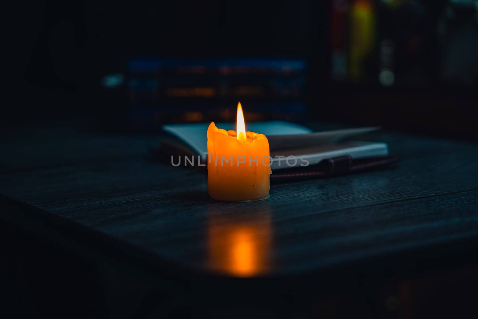 A notebook with a gold pen on the table in the candlelight. High quality photo