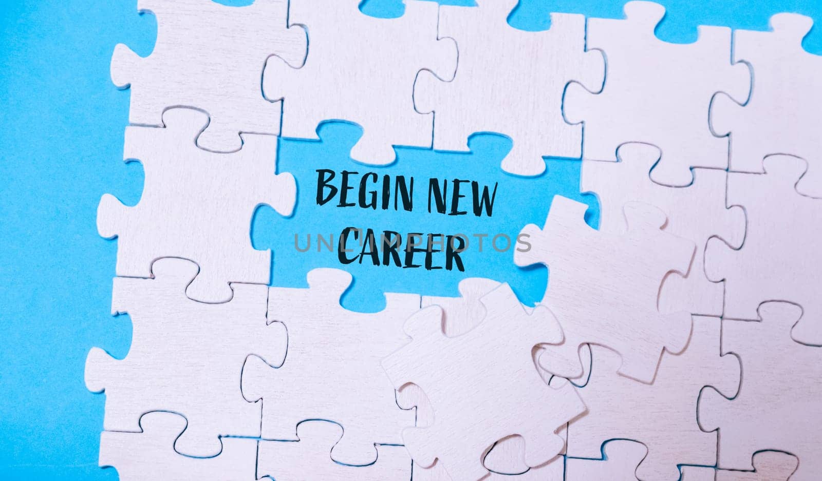 A puzzle with a word that says begin new career written in the middle. The puzzle is incomplete, with a piece missing