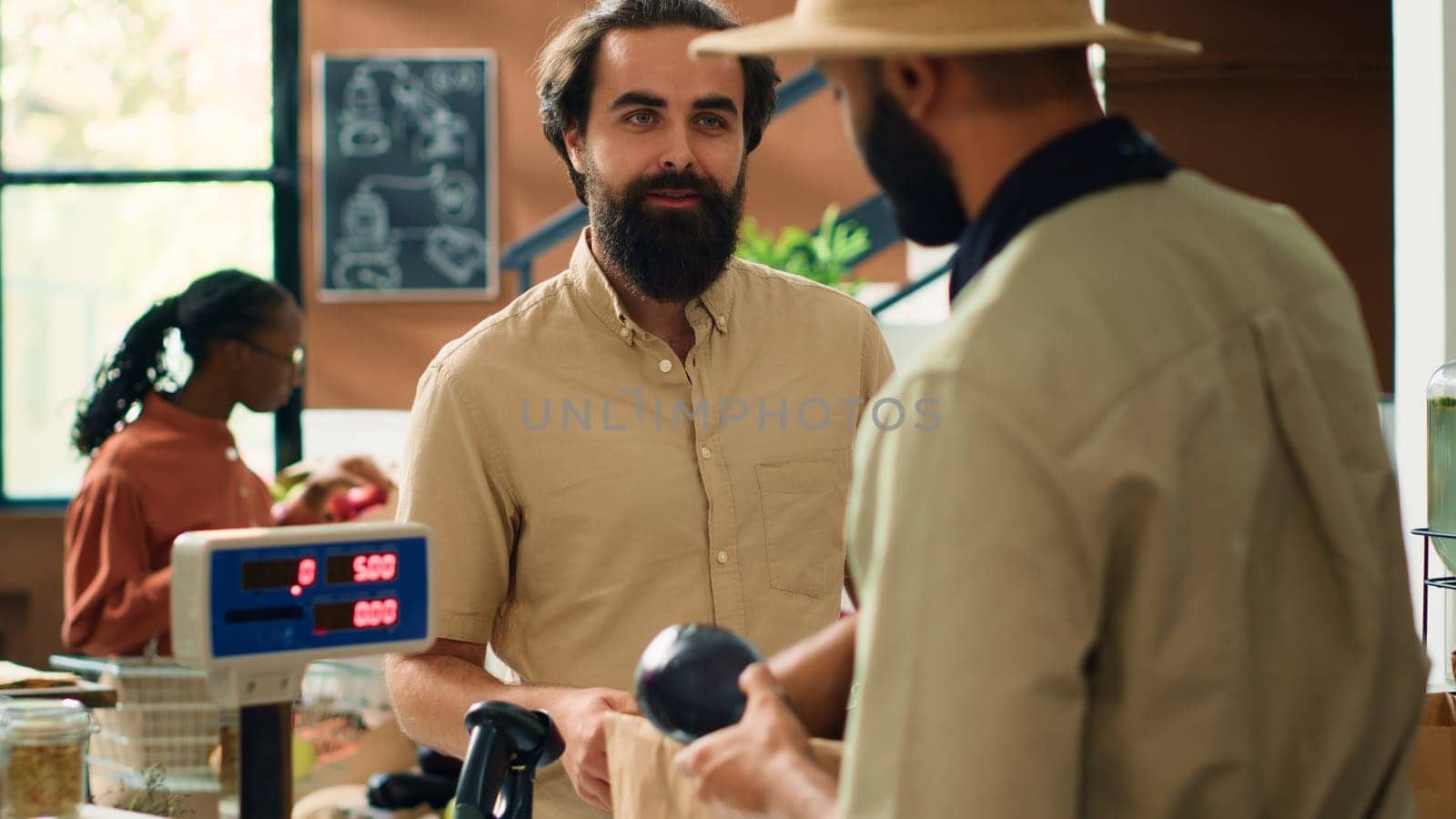 Shop owner serving man with produce by DCStudio