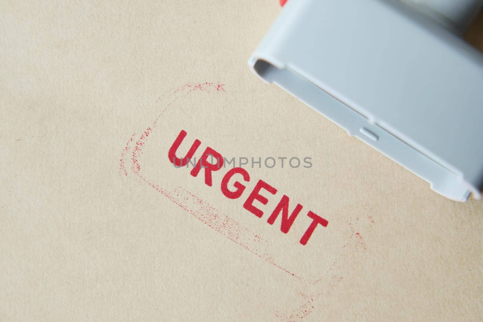 Red URGENT word stamp on a white paper ,