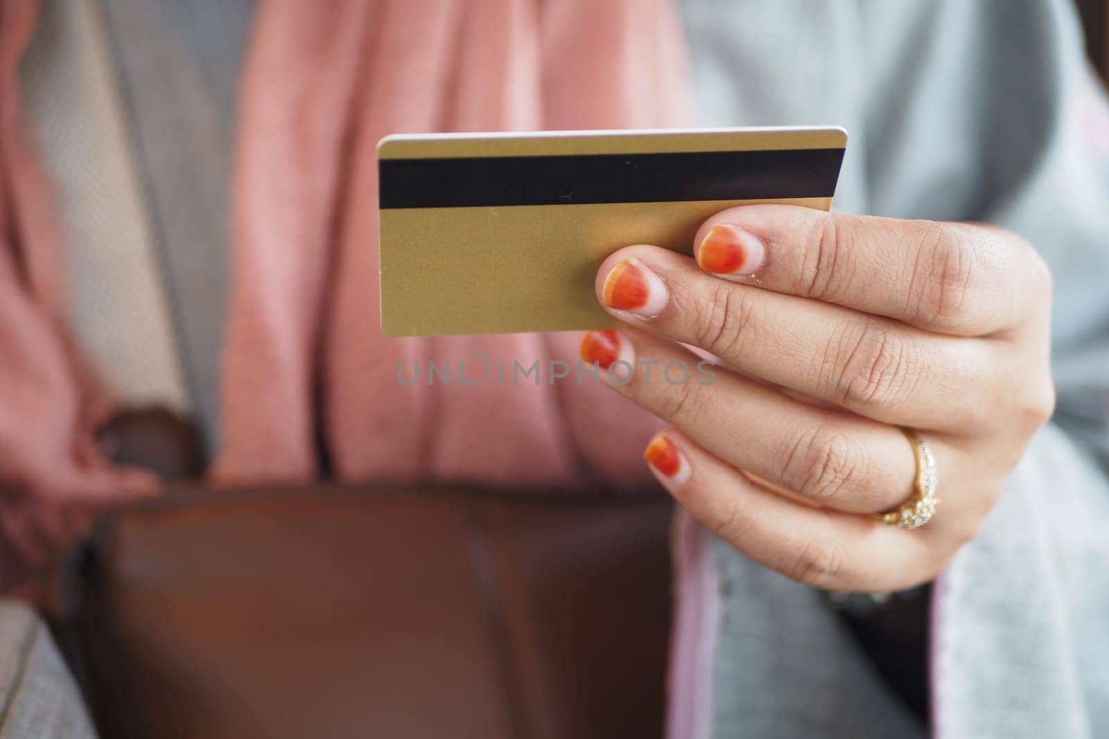 women hand holding credit card and using smart phone shopping online.