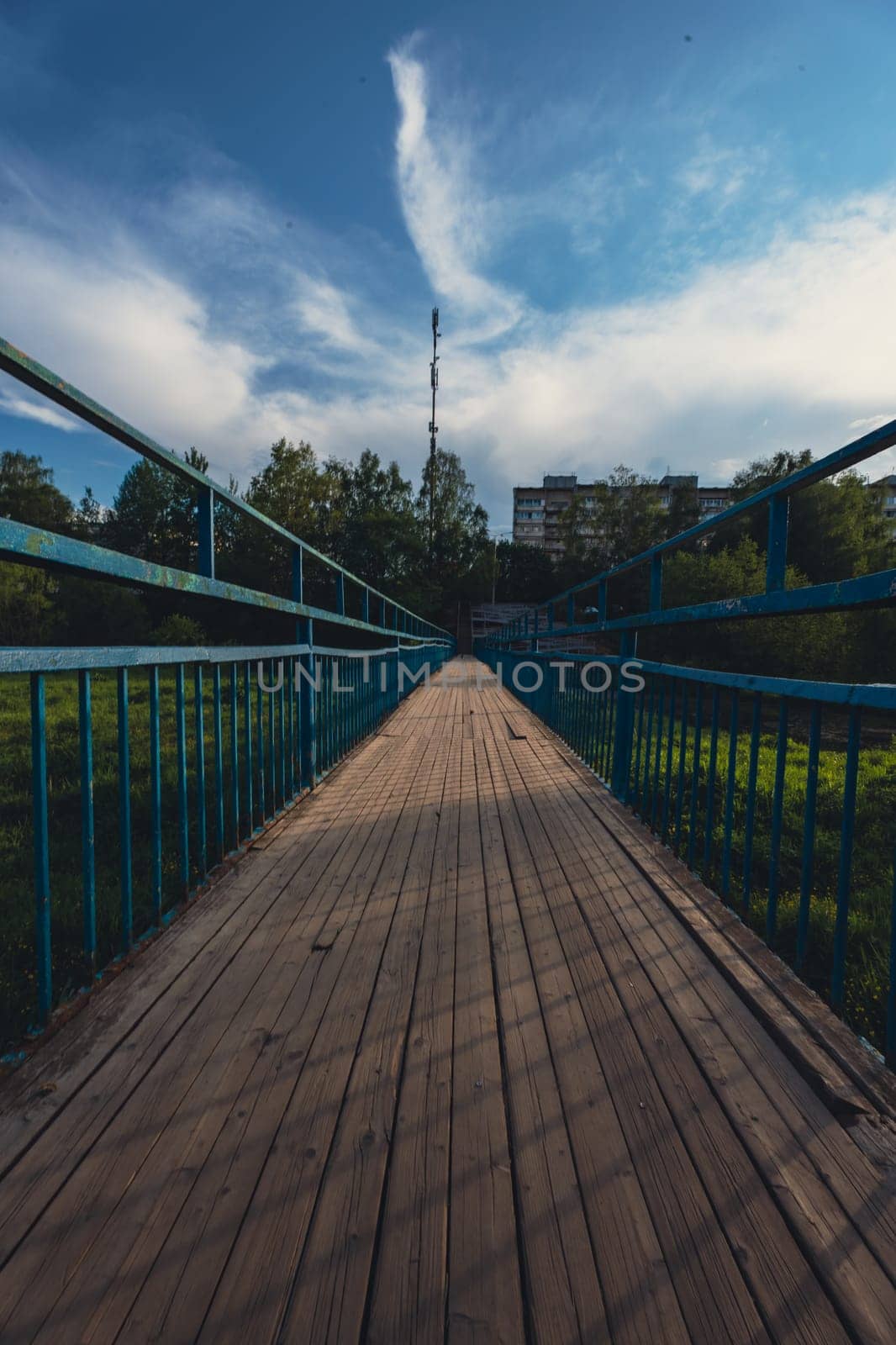 A wooden bridge across the river shot using an ultra-wide angle lens. High quality photo