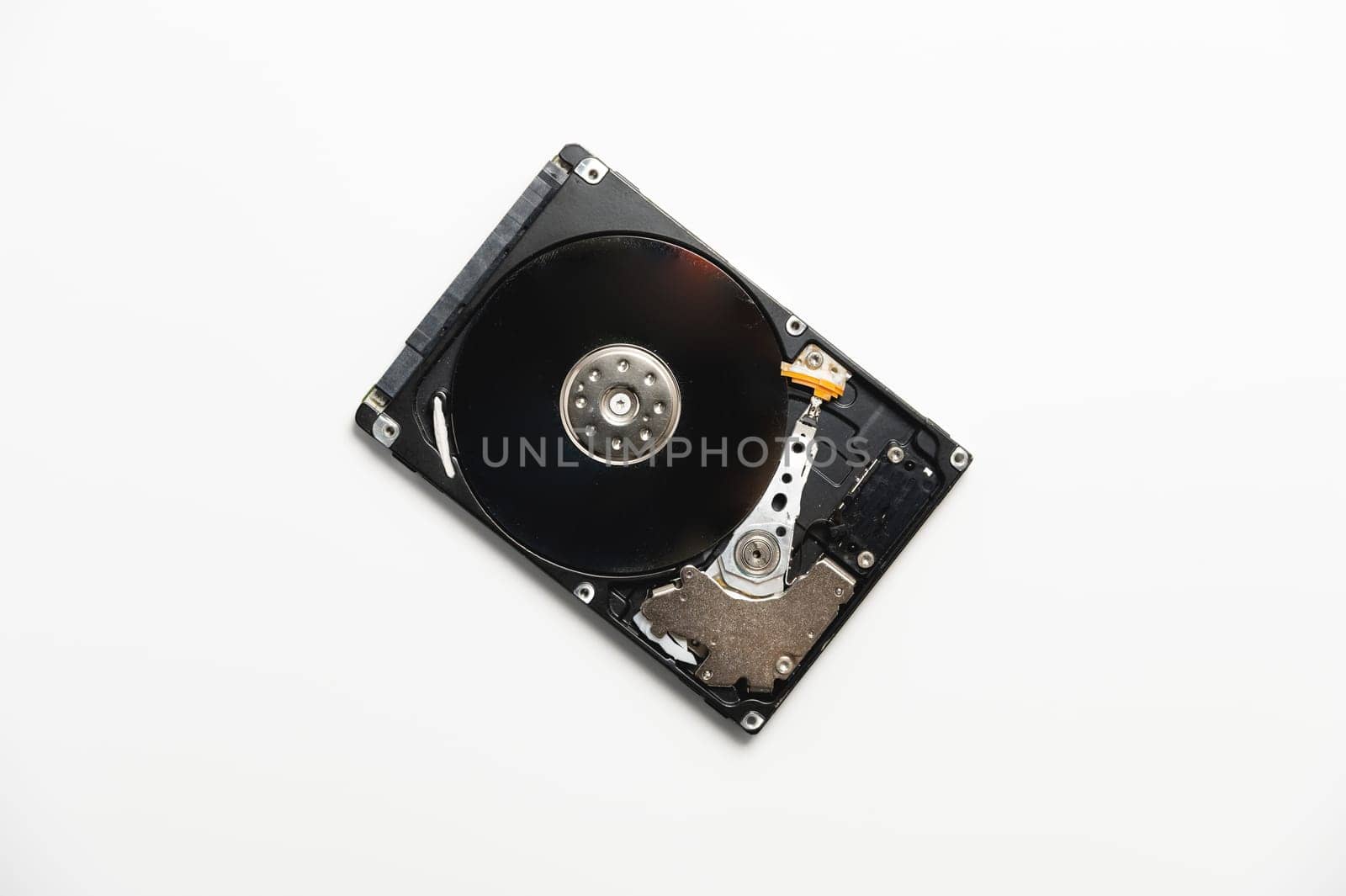 Hard drive from a PC disassembled on a white background. Data recovery concept by yanik88