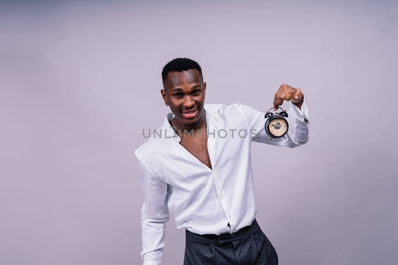 Time Management Concept. Shocked black man holding wall clock, running out of a time.