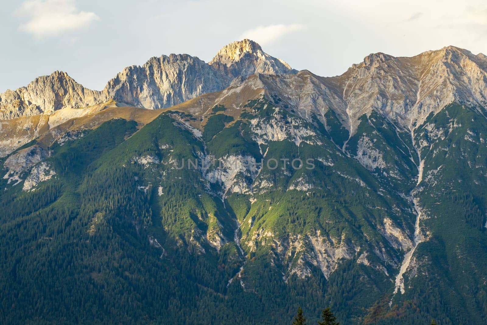 Beautiful mountain landscape sunset. Scenic view of a colorful sky above the mountains. Adventure travel concept. High quality photo