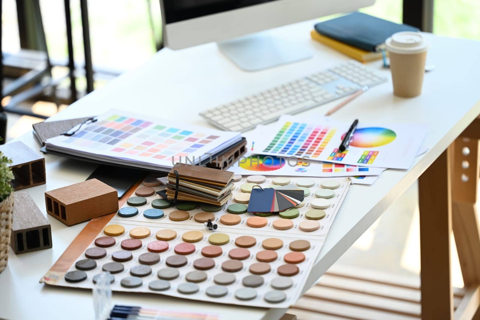 Interior designer working table with material sample and color swatches.