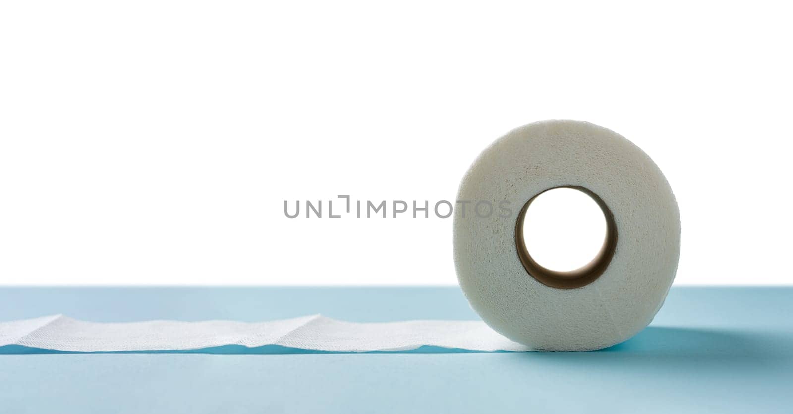 Top view of toilet paper roll on blue background