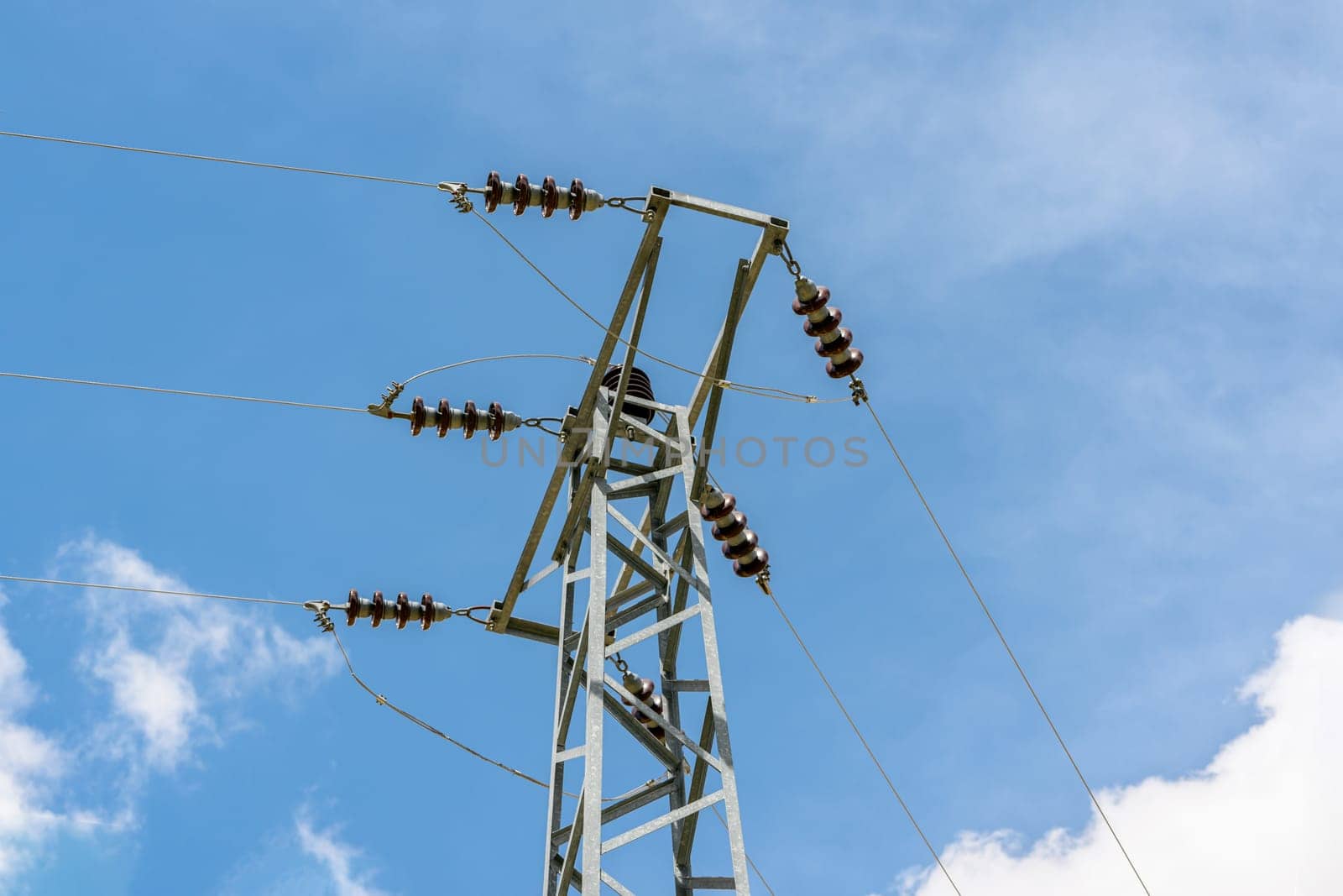 Ceramic insulators on electric poles and electrical wires passing on them